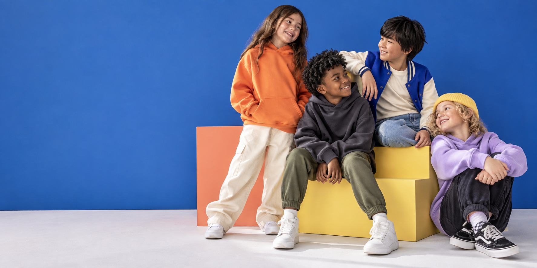 Four children wearing colorful, comfortable streetwear and spending time together